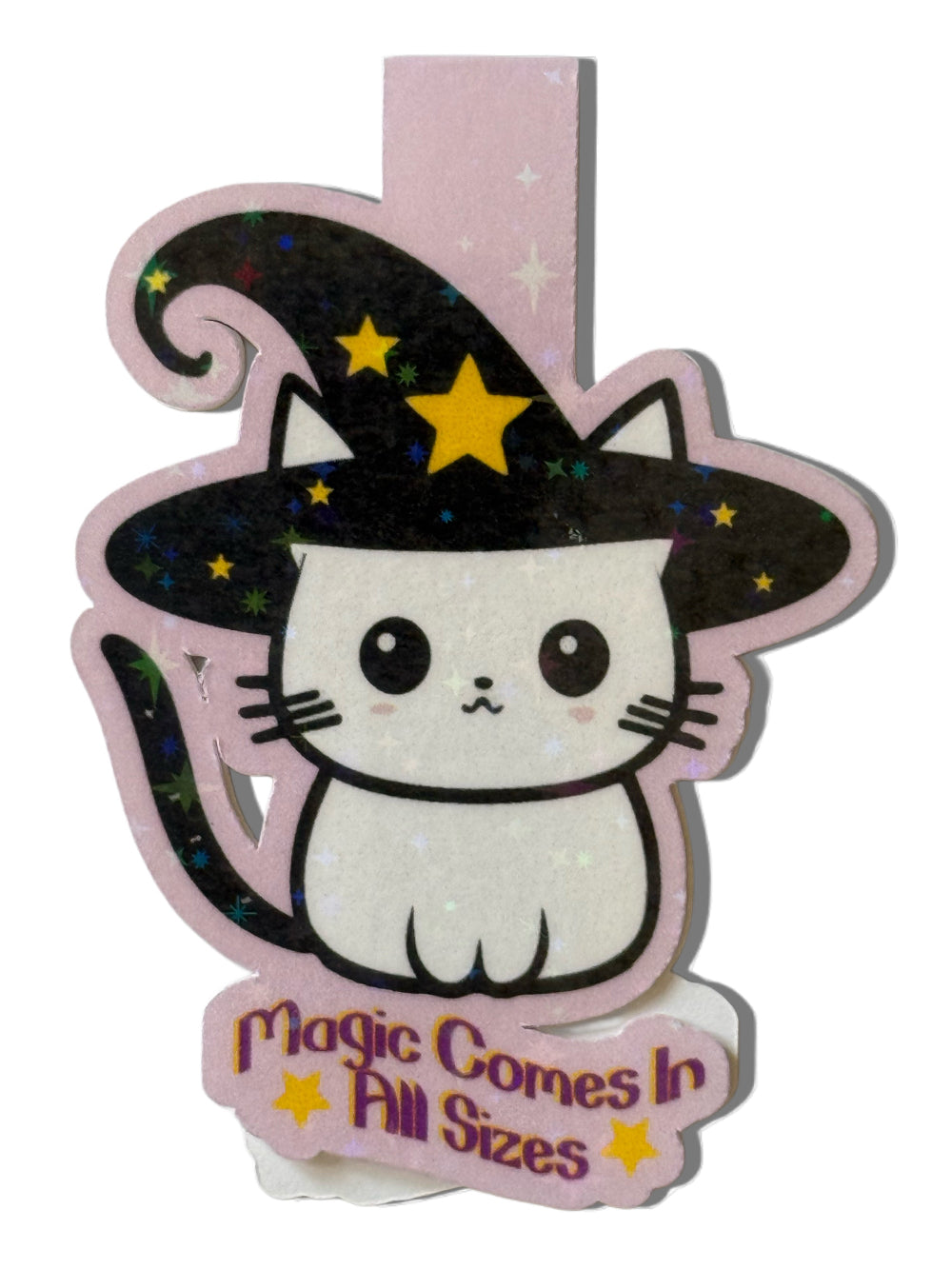 Cute cat in a witch hat with 'Magic Comes In All Sizes' text on a pink background