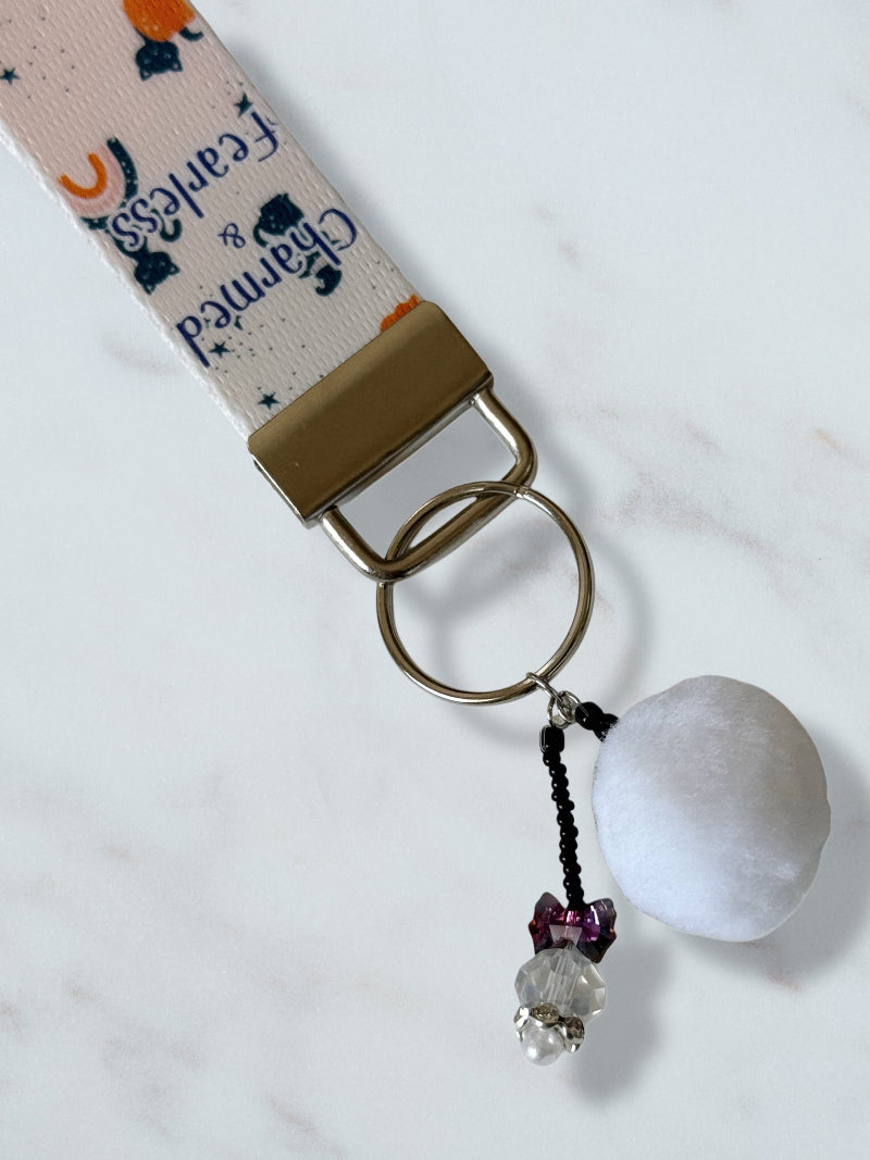 Keychain with decorative beads and a lanyard on a white background