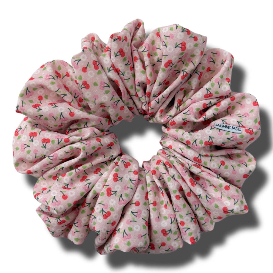Pink floral scrunchie on a white background