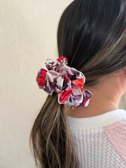 mini satin scrunchie with a bold rose floral print in red, pink, and purple, designed for thick and long hair, offering a secure and stylish hold.