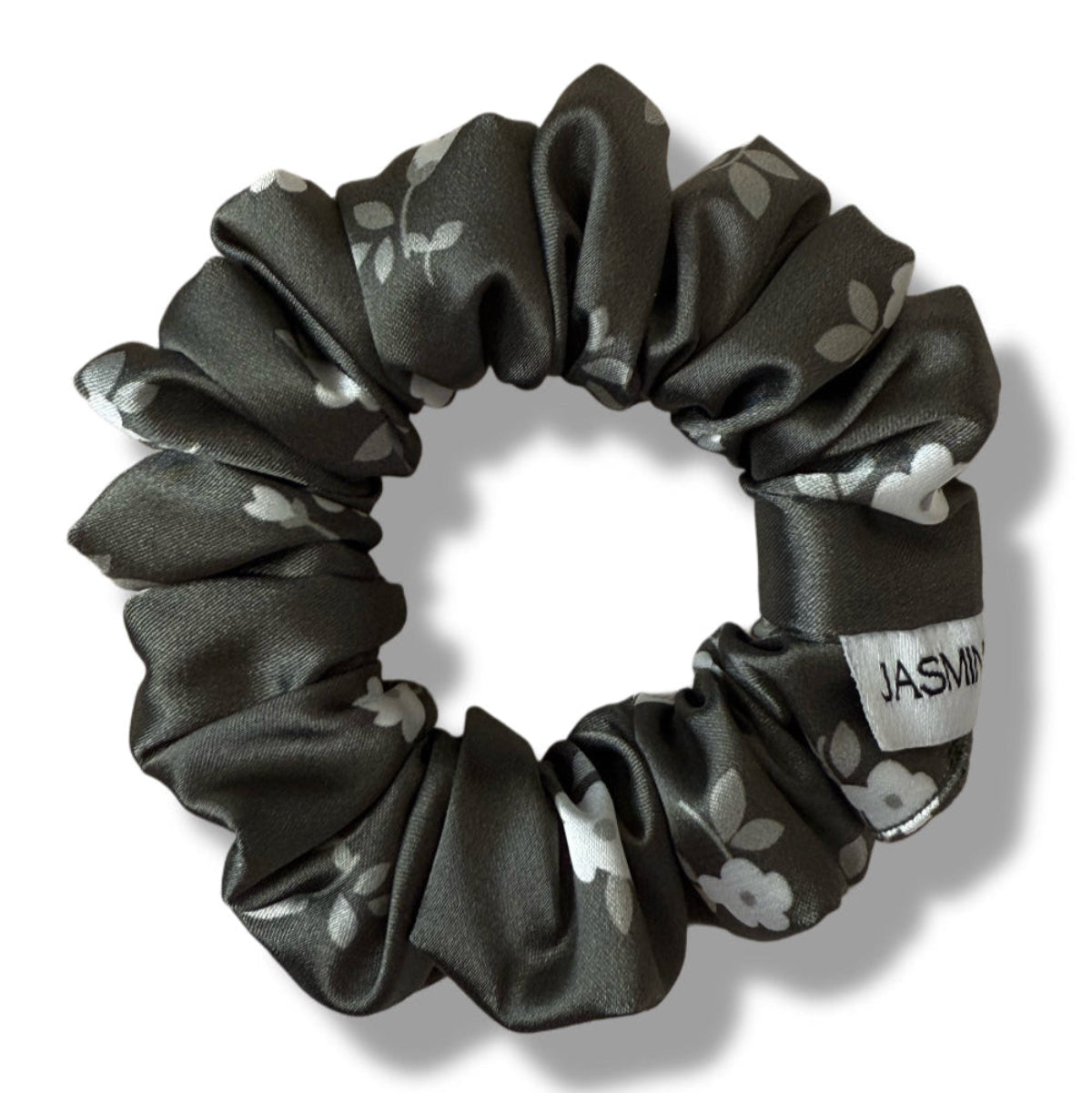 Black floral-patterned scrunchie on a white background