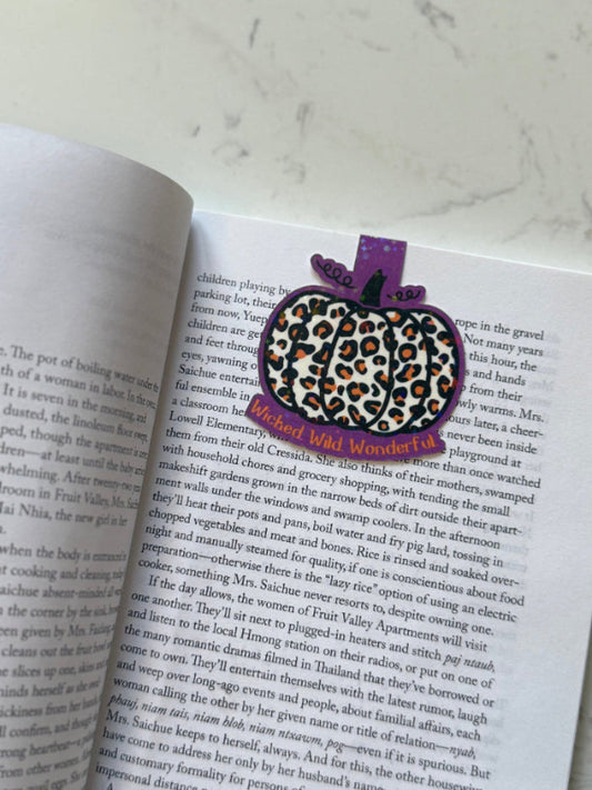 Leopard print bookmark on an open book with a white background