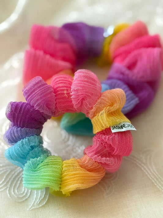 Colorful scrunchies on a textured surface