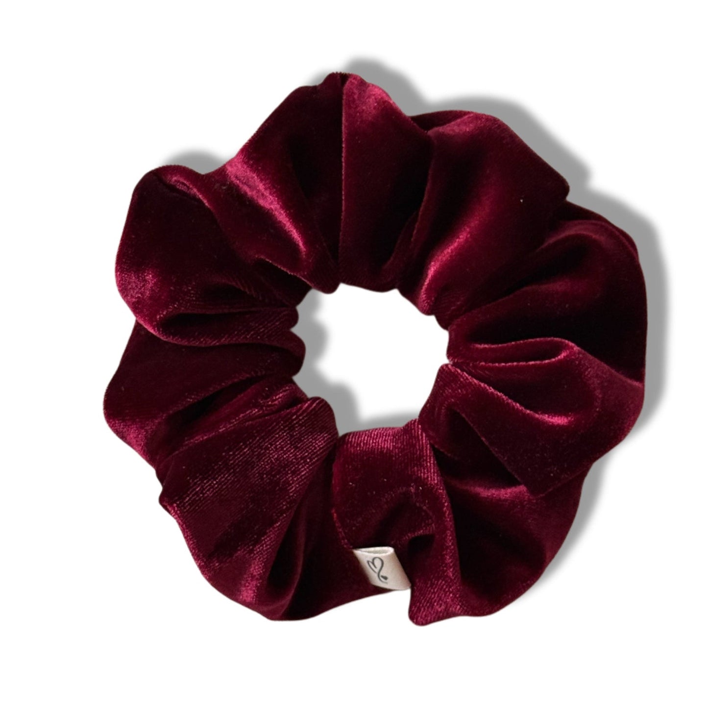 Maroon velvet scrunchie on a white background