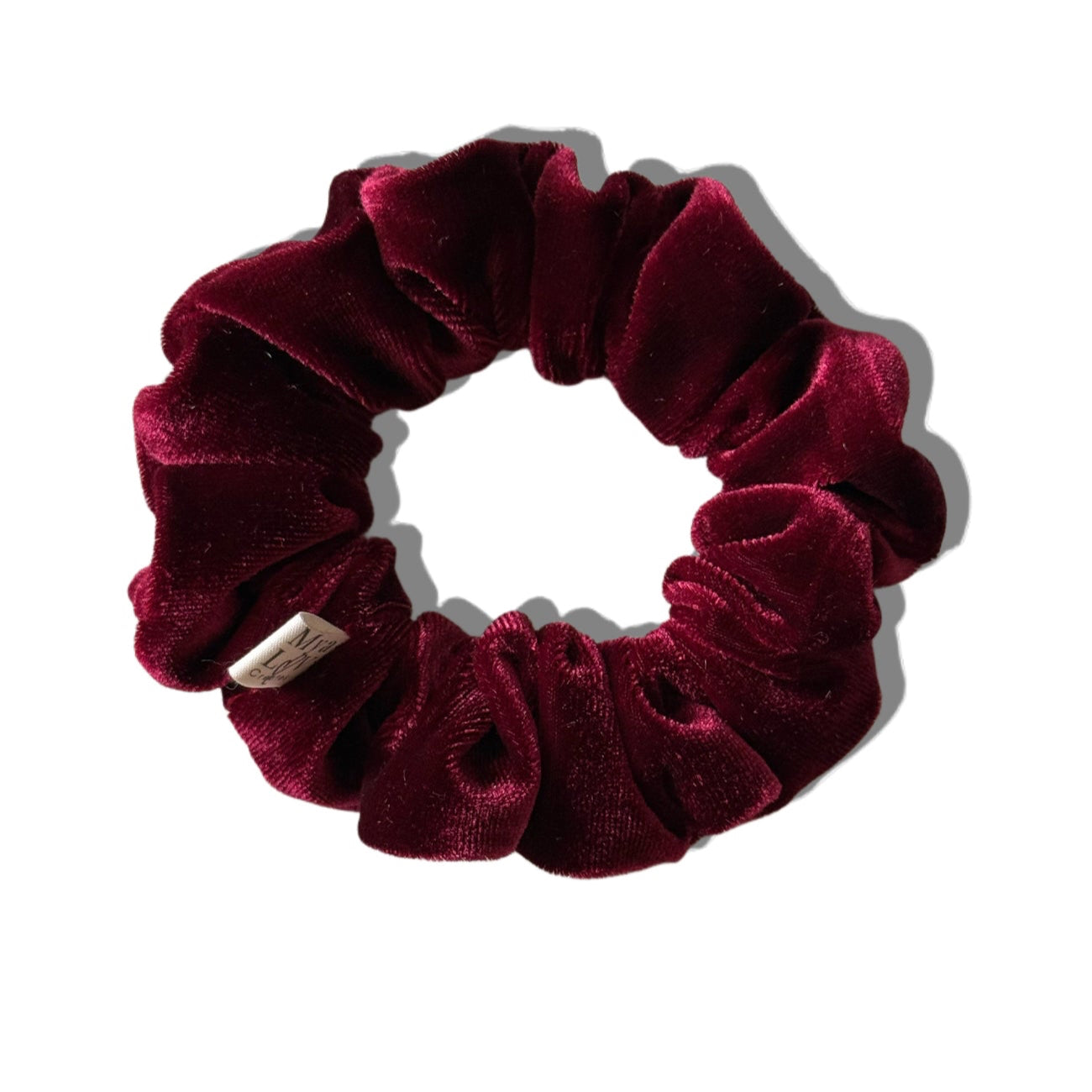 Maroon velvet scrunchie on a white background