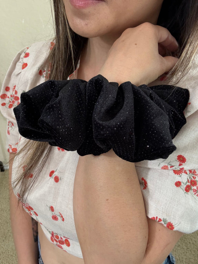 model wearing Starlit velvet xl scrunchie on wrist.