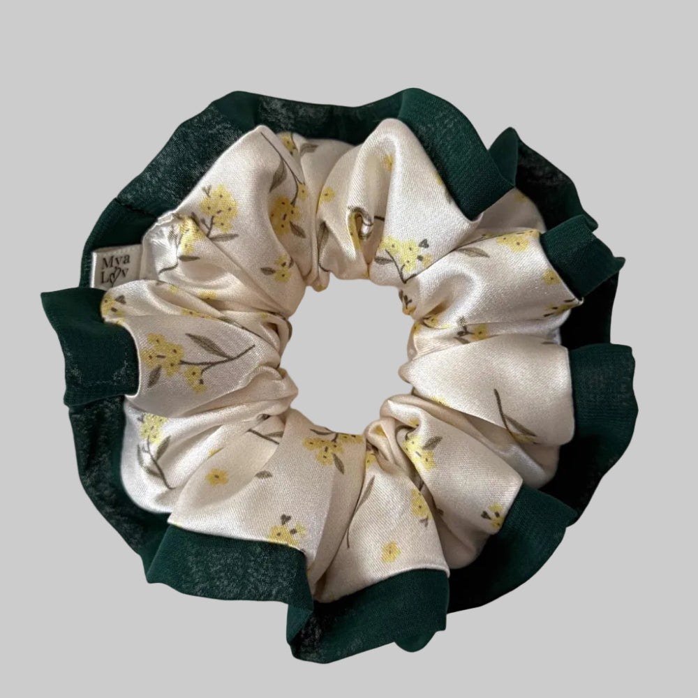 Floral scrunchie with green trim on a white background