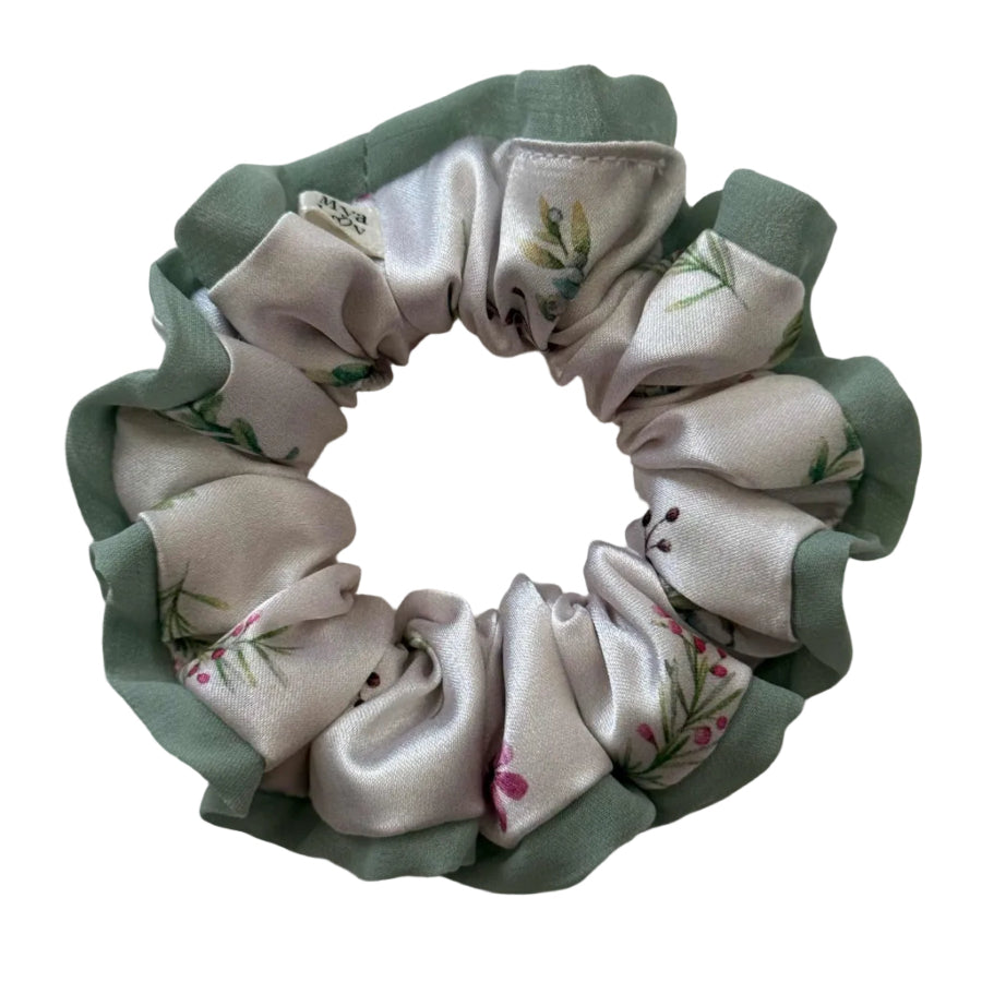 Fabric scrunchie with floral pattern on a light background