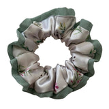 Fabric scrunchie with floral pattern on a light background