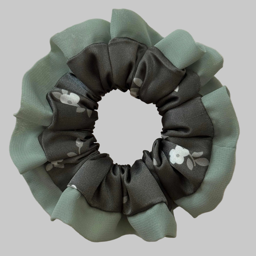 Green and gray scrunchie with floral design on a beige background