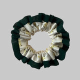 Green and white scrunchie on a beige background