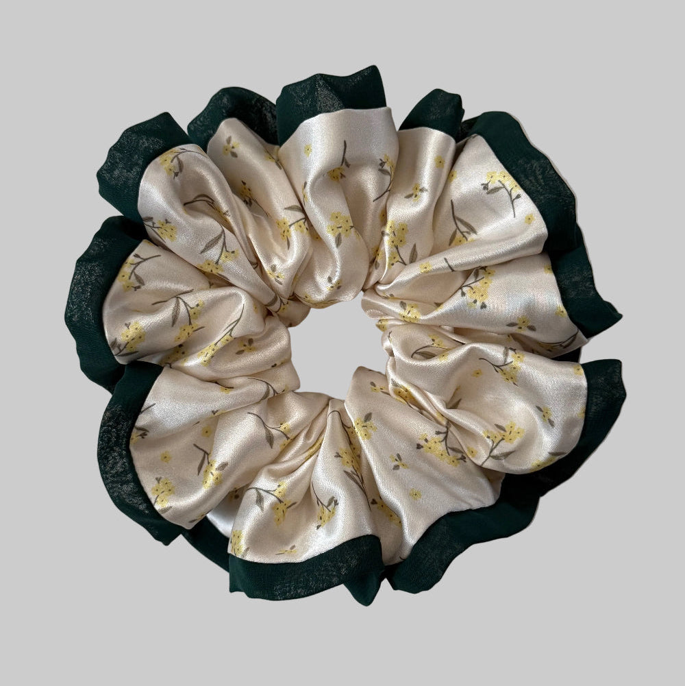 Silk scrunchie with floral pattern on a light background