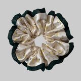 Silk scrunchie with floral pattern on a light background