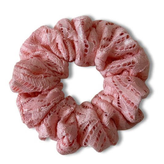 Pink lace scrunchie on a white background