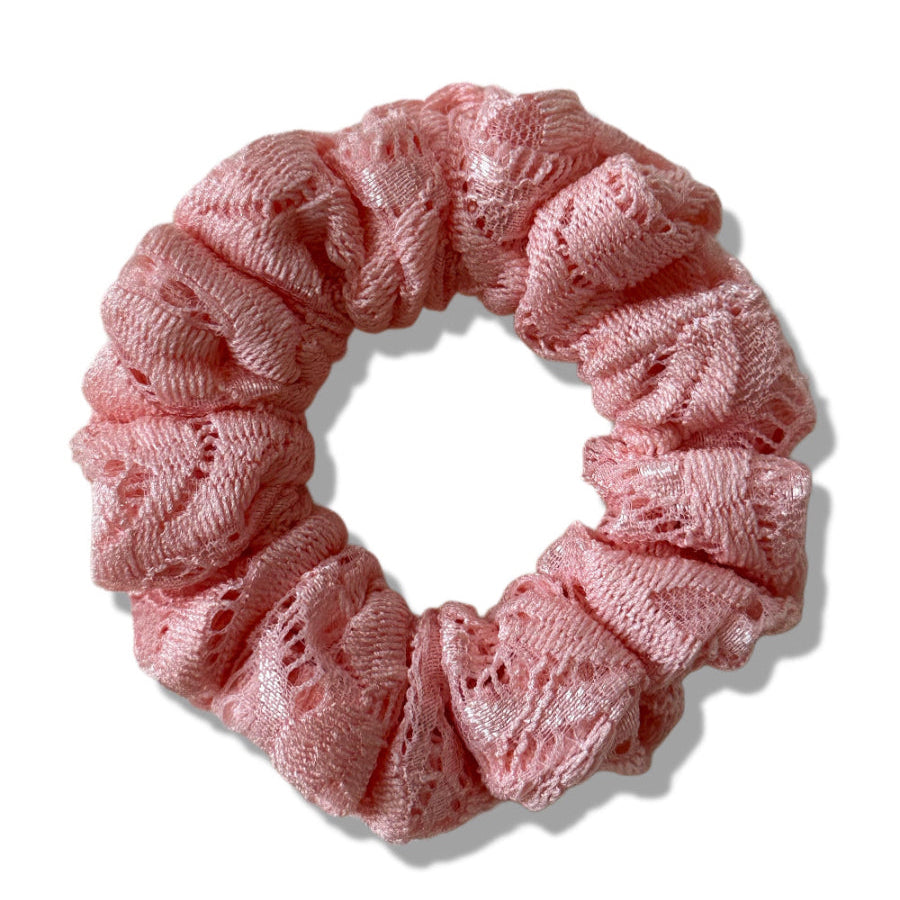 Pink lace scrunchie on a white background