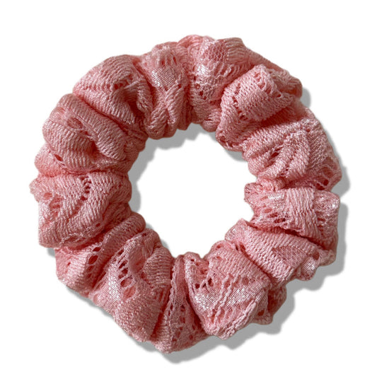 Pink lace scrunchie on a white background