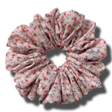 Pink floral scrunchie on a white background