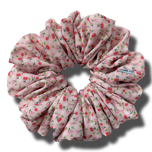 Pink floral scrunchie on a white background