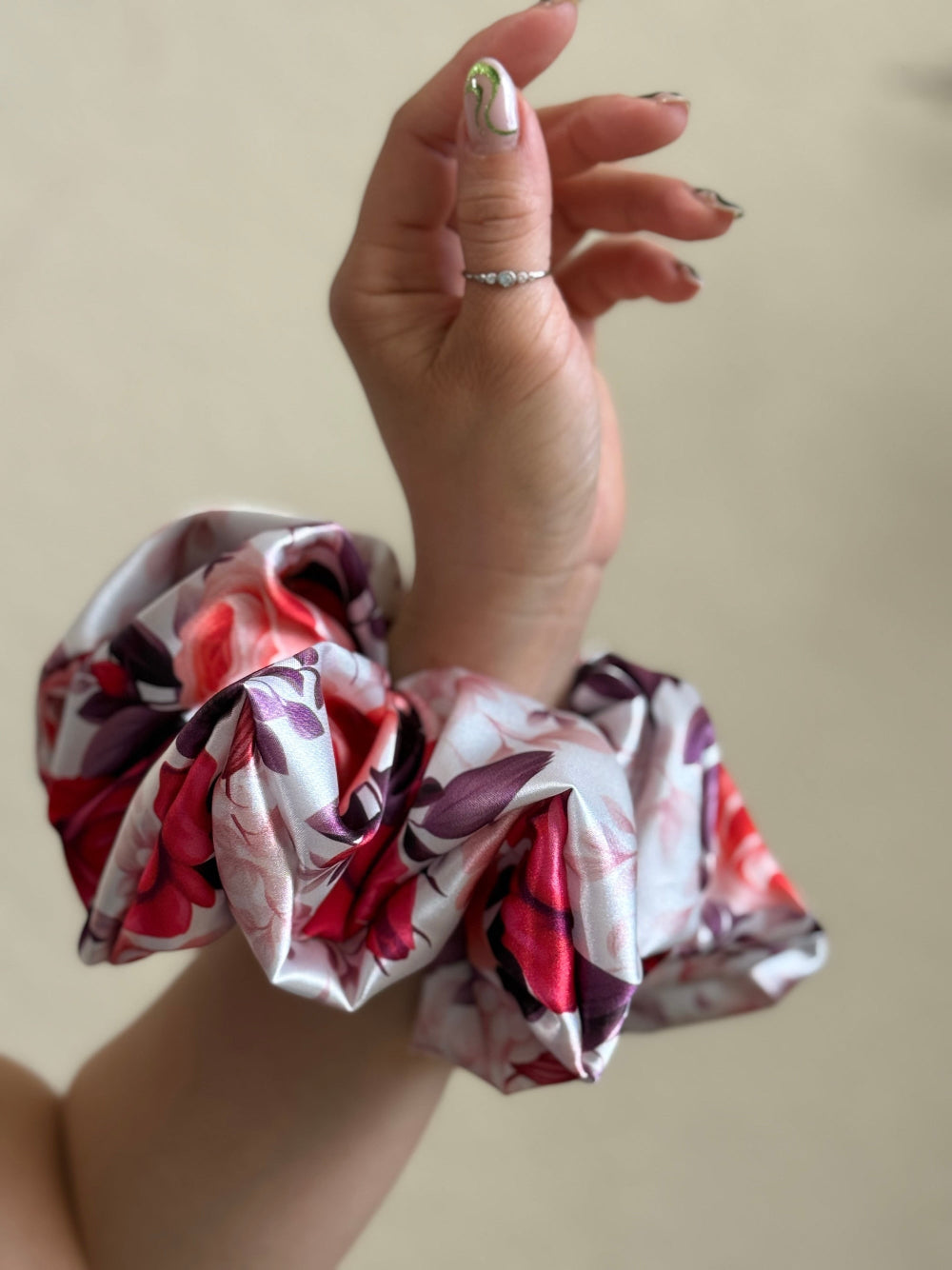 
XL satin scrunchie with a bold rose floral print in red, pink, and purple, designed for thick and long hair, offering a secure and stylish hold.