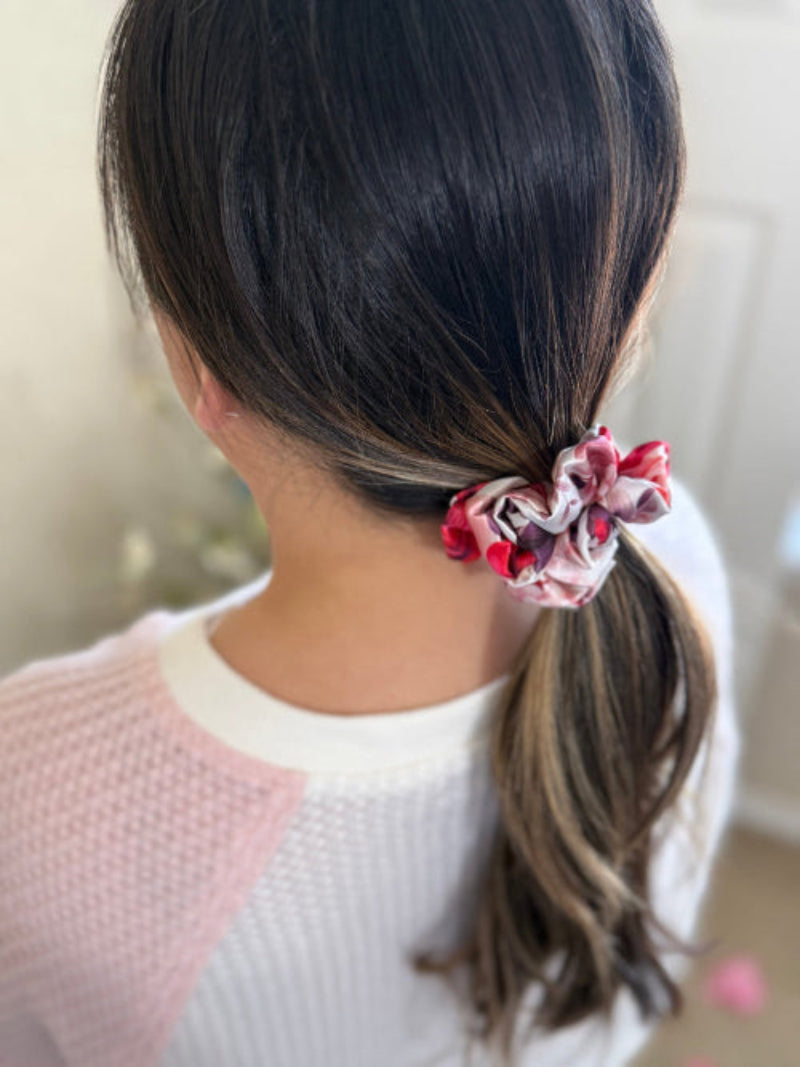 XS satin scrunchie with a bold rose floral print in red, pink, and purple, designed for everyday wear offering a secure and stylish hold.