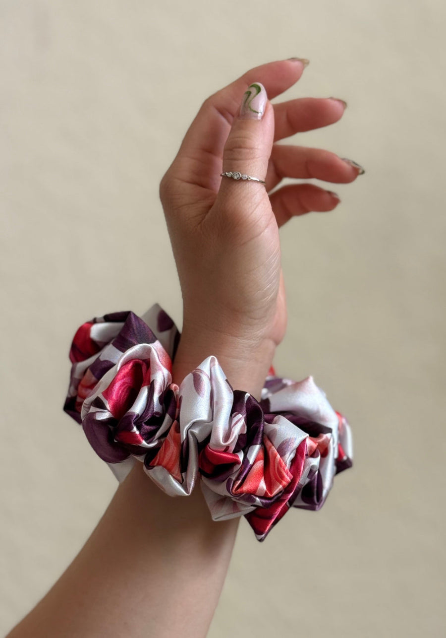 mini satin scrunchie with a bold rose floral print in red, pink, and purple, designed for thick and long hair, offering a secure and stylish hold.