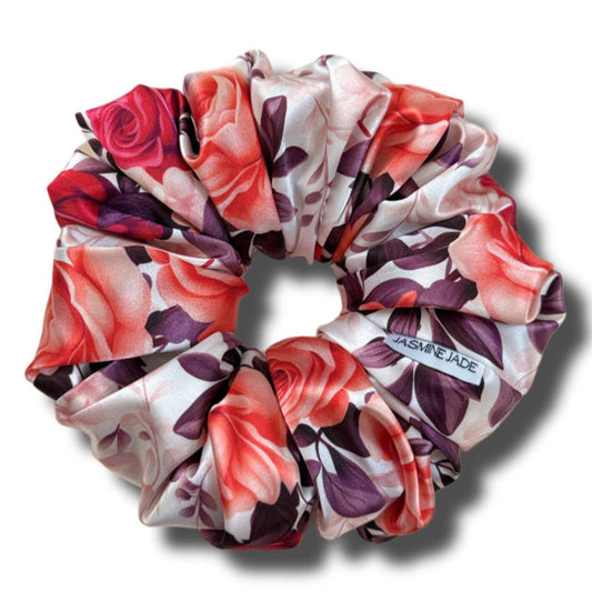 Floral patterned scrunchie with visible brand name on a white background