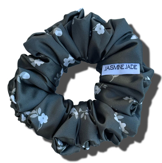 Dark gray scrunchie with floral pattern and  on a white background