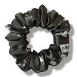 Black floral-patterned scrunchie on a white background