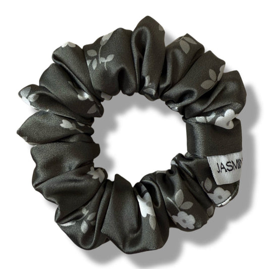 Black floral-patterned scrunchie on a white background