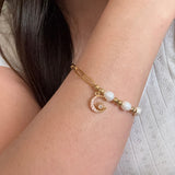 Gold bracelet with pearl beads on a person's wrist