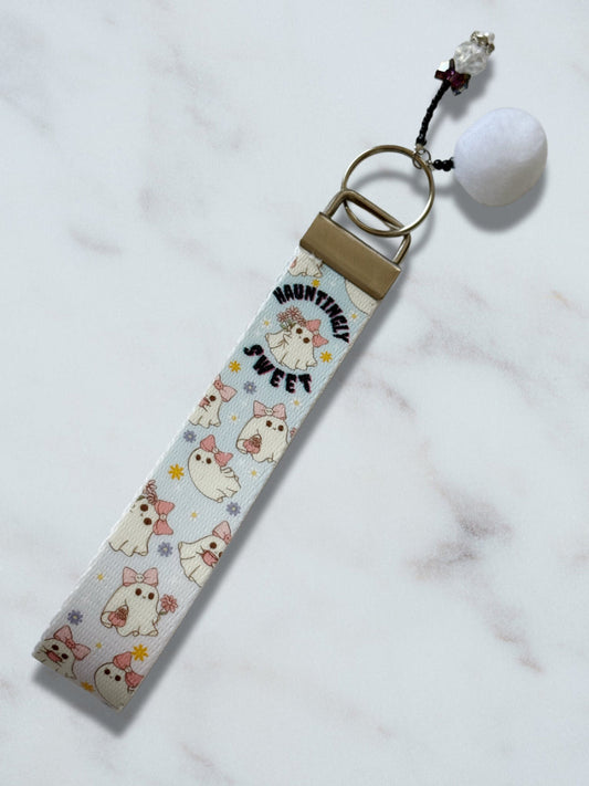 Keychain with cartoon dog design on a light blue background