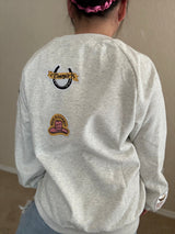 Back of cowgirl patch crewneck with horseshoe and pink cowboy hat embroidery