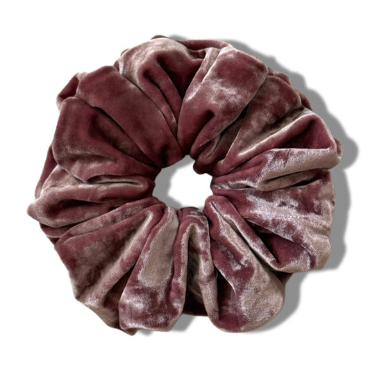 Pink velvet scrunchie on a white background
