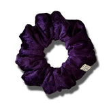 Purple scrunchie on a white background
