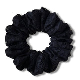 Black scrunchie on a white background