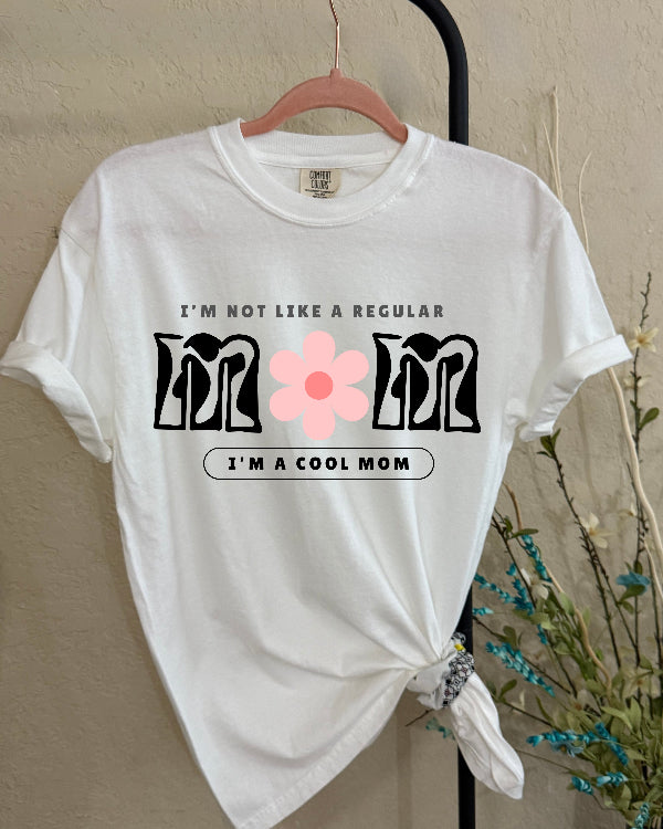 White t-shirt with text and graphic on a hanger against a neutral background