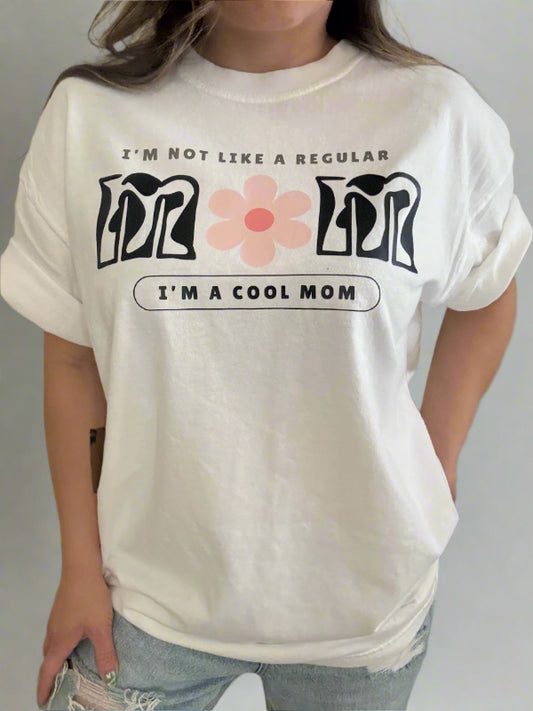 Person wearing a white t-shirt with graphic designs and text.