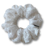 White lace scrunchie on a white background