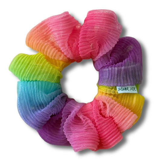 Multicolored scrunchie with a visible brand tag on a white background