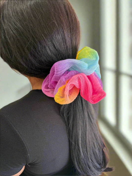 model wearing the glow girl rainbow jumbo scrunchie