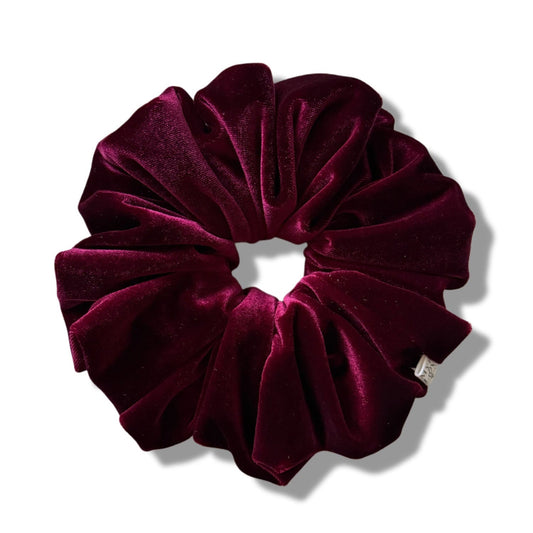Maroon velvet scrunchie on a white background