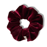 Maroon velvet scrunchie on a white background
