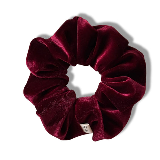Maroon velvet scrunchie on a white background