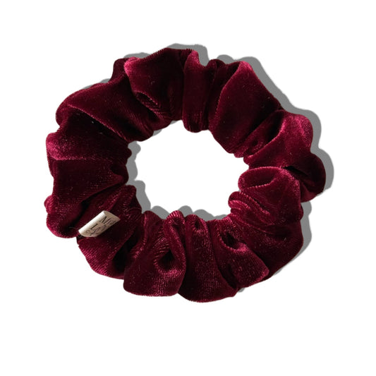 Maroon velvet scrunchie on a white background