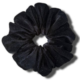 Black glittery scrunchie on a white background