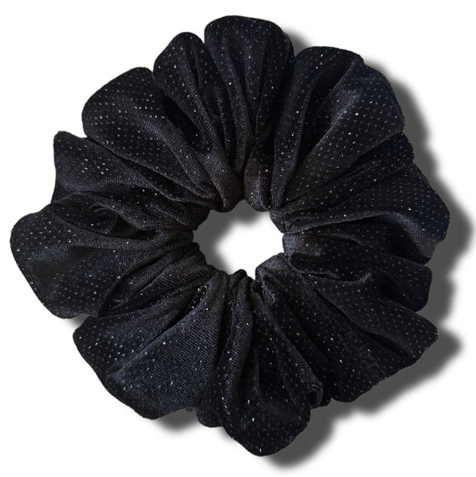 Black glittery scrunchie on a white background