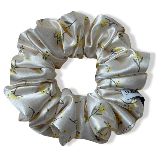 Floral patterned satin scrunchie on a white background