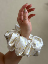 XL satin floral scrunchie in cream with delicate yellow flowers, perfect for thick and long hair, offering a secure and gentle hold.