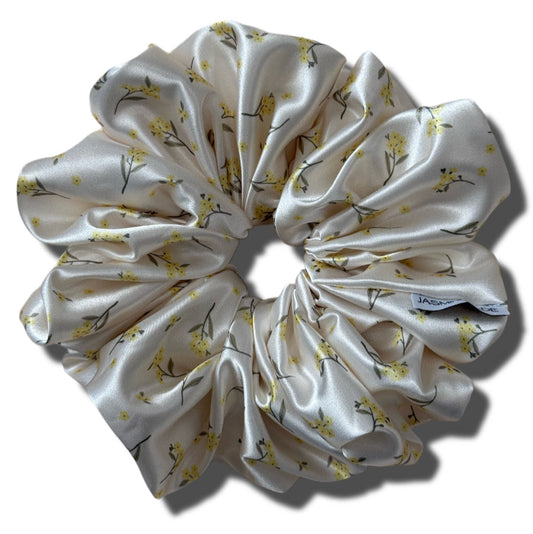 White fabric scrunchie with floral pattern on a white background