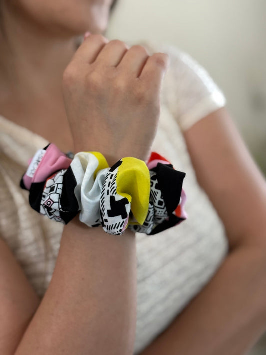 Close-up of a wrist with colorful hair ties.